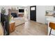 Bright living room with a stone fireplace, comfortable seating, and wood-look flooring at 4793 S Swadley St, Morrison, CO 80465
