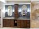 Bathroom vanity featuring granite countertop, and sinks, and dark wood cabinetry at 226 Hidden Valley Ln, Castle Rock, CO 80108