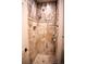 Bathroom showcasing a stone-tiled shower, decorative shelves, and glass door at 226 Hidden Valley Ln, Castle Rock, CO 80108