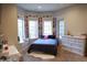 Bright bedroom featuring a bed beneath a bay window and white dressers for storage at 226 Hidden Valley Ln, Castle Rock, CO 80108