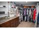 Walk-in closet with custom shelving, drawers, hanging rods, granite countertops, and carpet flooring at 226 Hidden Valley Ln, Castle Rock, CO 80108