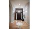 Bright entryway with hardwood floors, a modern chandelier, and a dark wood front door at 226 Hidden Valley Ln, Castle Rock, CO 80108