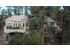 Beautiful home with a stone facade, a balcony and a lush green landscape with mature trees at 226 Hidden Valley Ln, Castle Rock, CO 80108