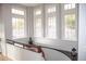 Hallway with hardwood floors, trim and wainscoting with 4 large windows overlooking the outdoor space at 226 Hidden Valley Ln, Castle Rock, CO 80108