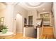 Hallway with hardwood floors, stairs with railing, and decoratively painted neutral-colored walls at 226 Hidden Valley Ln, Castle Rock, CO 80108