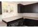 Laundry room with dark cabinets, a folding counter, modern appliances, and natural lighting at 226 Hidden Valley Ln, Castle Rock, CO 80108