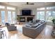 Open concept living room with hardwood floors, a fireplace, comfortable seating and lots of natural light at 226 Hidden Valley Ln, Castle Rock, CO 80108