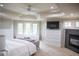 Primary bedroom with tray ceiling, fireplace and large windows with scenic views at 226 Hidden Valley Ln, Castle Rock, CO 80108