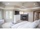 Primary bedroom with tray ceiling, fireplace, a sitting area, and natural light at 226 Hidden Valley Ln, Castle Rock, CO 80108