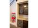 Attractive wet bar with beverage fridge, granite counters, and wood cabinets next to a popcorn machine at 226 Hidden Valley Ln, Castle Rock, CO 80108