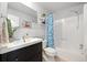 Bathroom featuring a dark vanity, mosaic backsplash, and blue patterned shower curtain at 9240 W 49Th Ave # 317, Wheat Ridge, CO 80033