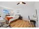 Light-filled bedroom with hardwood floors, a ceiling fan and large window at 9240 W 49Th Ave # 317, Wheat Ridge, CO 80033