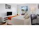 Bright bedroom with hardwood floors and a large window showing trees at 9240 W 49Th Ave # 317, Wheat Ridge, CO 80033