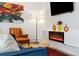 Bright living room features modern fireplace and decor, with a comfortable chair and lots of natural light at 9240 W 49Th Ave # 317, Wheat Ridge, CO 80033