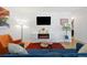 Bright living room with an orange accent chair, modern fireplace, and stylish decor at 9240 W 49Th Ave # 317, Wheat Ridge, CO 80033