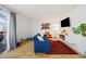 Bright living room features a comfortable blue sofa, stylish decor, and a sliding glass door to a balcony at 9240 W 49Th Ave # 317, Wheat Ridge, CO 80033