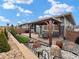 Landscaped backyard with stone ground cover, a small patio, and a gazebo with outdoor seating at 4538 Hidden Gulch Rd, Castle Rock, CO 80104