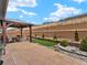 Private backyard with a covered patio, seating area, manicured landscaping, and a retaining wall at 4538 Hidden Gulch Rd, Castle Rock, CO 80104