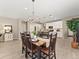 Open concept dining area with a chandelier, wooden table, and views of the adjacent kitchen at 4538 Hidden Gulch Rd, Castle Rock, CO 80104