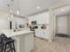 Bright kitchen with white cabinetry, quartz countertops, stainless appliances and breakfast bar seating at 4538 Hidden Gulch Rd, Castle Rock, CO 80104