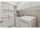 Clean and organized laundry room with ample cabinet space and a washer and dryer at 4538 Hidden Gulch Rd, Castle Rock, CO 80104