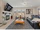 Inviting living room with fireplace, ceiling fan, large TV, and plush seating at 4538 Hidden Gulch Rd, Castle Rock, CO 80104