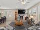 Comfortable living area with fireplace, media center, light-colored floors and dining area at 4538 Hidden Gulch Rd, Castle Rock, CO 80104