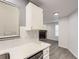 Kitchen with white cabinets and view of living room fireplace at 932 S Dearborn Way # 8, Aurora, CO 80012