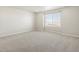Large bedroom with plush carpeting, a window, and natural light at 8879 Sedalia St, Commerce City, CO 80022