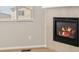Inviting living space featuring a modern fireplace with a tile surround and wood-look flooring at 8879 Sedalia St, Commerce City, CO 80022