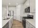 Well-lit kitchen showcasing white cabinets, stainless steel appliances, and a central island for meal prep at 8879 Sedalia St, Commerce City, CO 80022