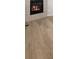 Cozy stone fireplace with modern flooring at 8879 Sedalia St, Commerce City, CO 80022
