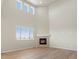 Bright living room features tall ceilings, a large window, and a stone fireplace at 8879 Sedalia St, Commerce City, CO 80022