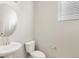 Neat powder room featuring a pedestal sink, modern fixtures, and a window for natural light at 8879 Sedalia St, Commerce City, CO 80022