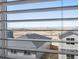 Picturesque view through blinds showcasing the neighborhood and mountain range in the distance at 8879 Sedalia St, Commerce City, CO 80022