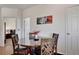 Well-lit dining room with modern table set, hardwood floors, and convenient access to other rooms at 2428 W 82Nd Pl # 3A, Westminster, CO 80031