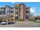 Three-story apartment building with brick and siding, offering reserved parking and lush landscaping at 2428 W 82Nd Pl # 3A, Westminster, CO 80031