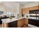 Well-lit kitchen with light wood cabinets and modern appliances at 2428 W 82Nd Pl # 3A, Westminster, CO 80031