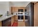 Functional kitchen with light wood cabinets and standard black appliances at 2428 W 82Nd Pl # 3A, Westminster, CO 80031