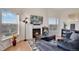 Bright living room with hardwood floors, a cozy fireplace, and plenty of natural light at 2428 W 82Nd Pl # 3A, Westminster, CO 80031