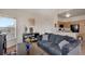 Comfortable living room featuring a dark sofa and an adjacent kitchen area at 2428 W 82Nd Pl # 3A, Westminster, CO 80031