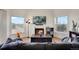 Bright living room with hardwood floors, a cozy fireplace, and plenty of natural light at 2428 W 82Nd Pl # 3A, Westminster, CO 80031
