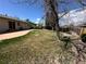 A sprawling backyard with mature trees, green grass, and a privacy fence at 12831 E Mexico Ave, Aurora, CO 80012
