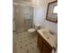 A full bathroom includes a walk-in shower, modern fixtures, and classic vanity with sink at 12831 E Mexico Ave, Aurora, CO 80012