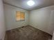 A cozy bedroom features a window, neutral walls, and soft carpet at 12831 E Mexico Ave, Aurora, CO 80012
