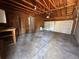 Spacious garage with exposed wood beams, a workbench, and an insulated garage door at 12831 E Mexico Ave, Aurora, CO 80012