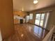 Eat-in kitchen featuring wood cabinets, laminate flooring, and sliding glass door to the backyard at 12831 E Mexico Ave, Aurora, CO 80012