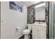 Small bathroom featuring patterned wallpaper, shower, white vanity and toilet at 8610 Jolene Dr, Denver, CO 80229