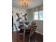 Cozy dining area featuring a stylish chandelier, hardwood floors, and artwork at 8610 Jolene Dr, Denver, CO 80229
