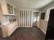 Eat-in kitchen featuring white cabinets, view to living, and contemporary style at 8610 Jolene Dr, Denver, CO 80229